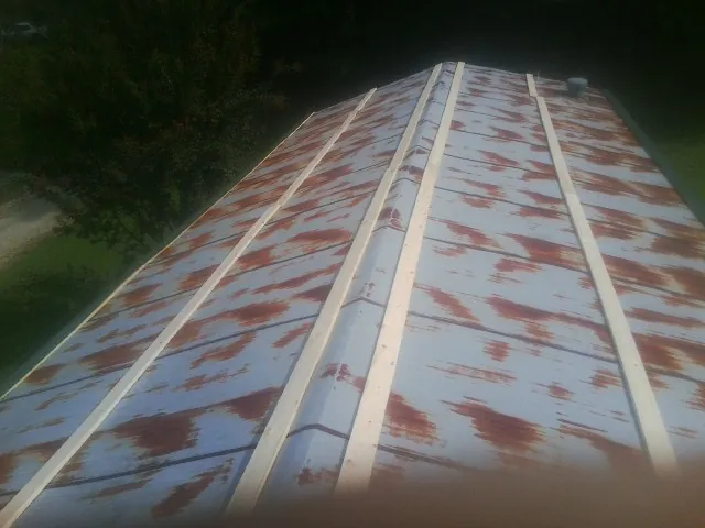 Rusted metal roof panels with new wood purlins before replacement — Storm Damage Roof Repair in Damascus by Roofing Brothers